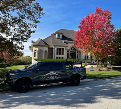 O’Danny Boy truck parked at a residential roof replacement project, outside a home with beige siding and brown shingles